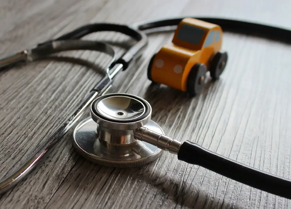 A stethoscope placed near a car, symbolizing a car accident doctor and medical evaluation after an accident.