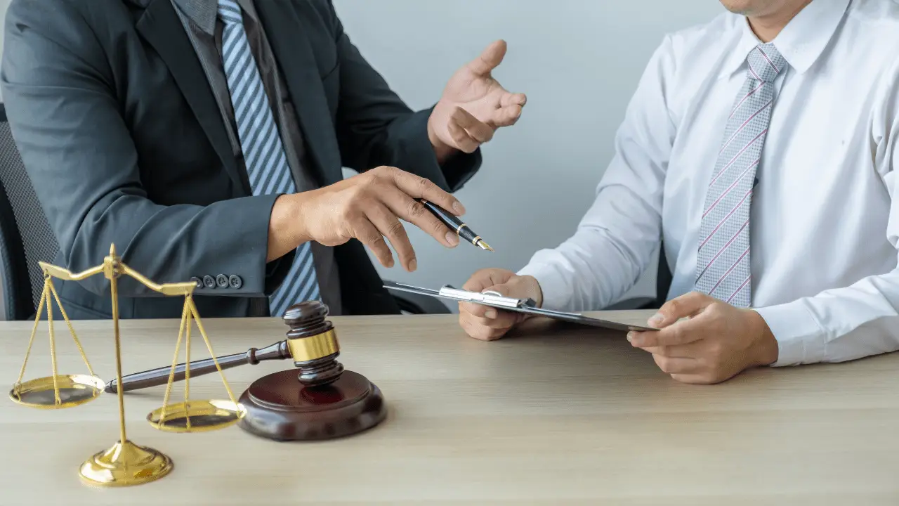 Car accident lawyer consulting with injured client in Houston office.