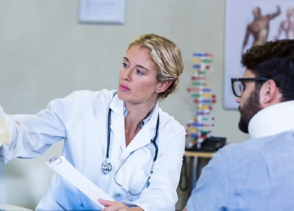 A doctor providing guidance and support to a patient during a clinic session.