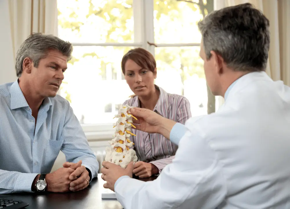 showing lower spine degeneration and disc pressure due to aging and strain.